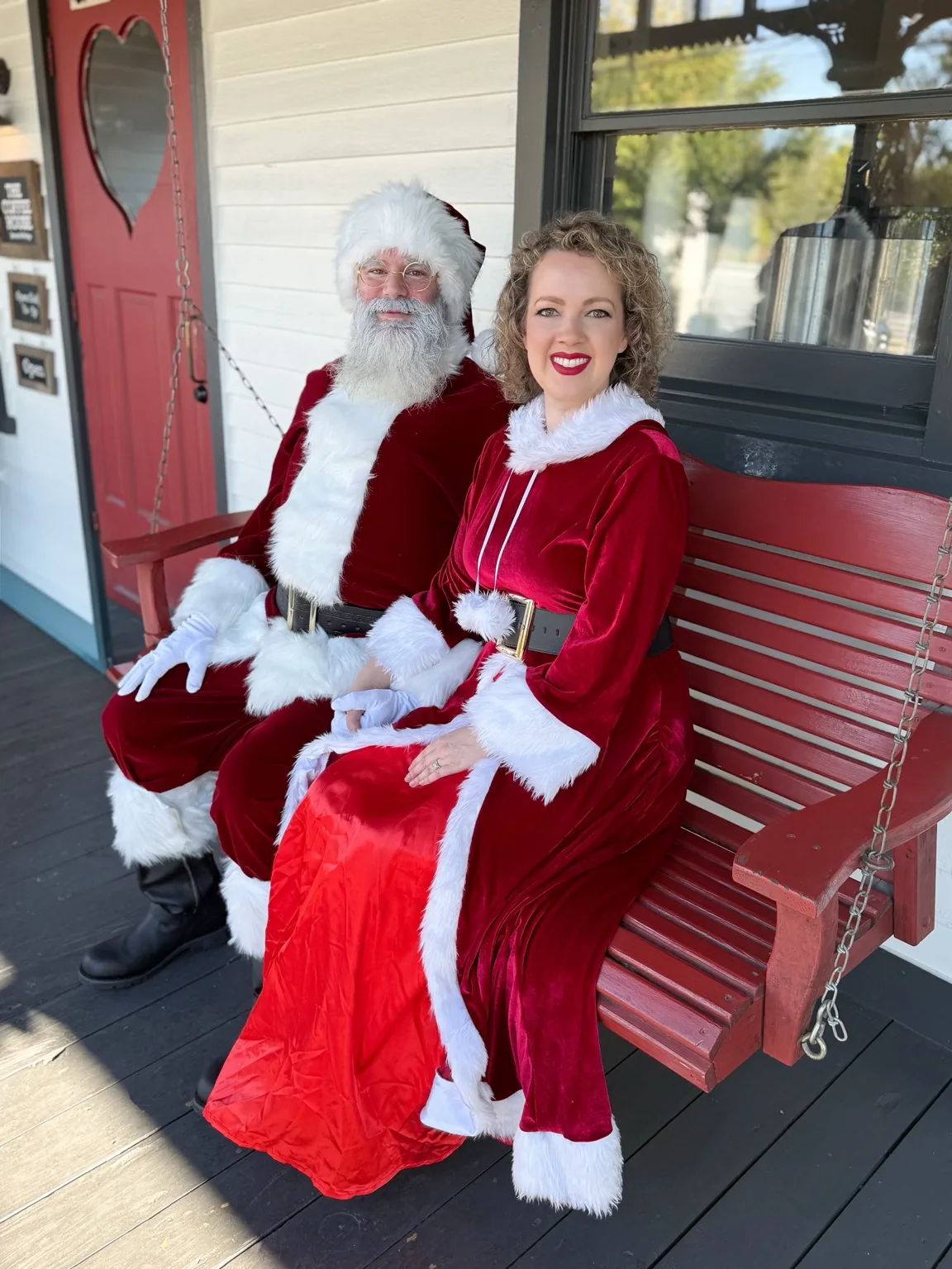 Santa and Mrs. Claus relaxing together on a porch
